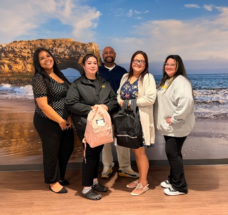 Primary care team showcasing the backpacks they donated